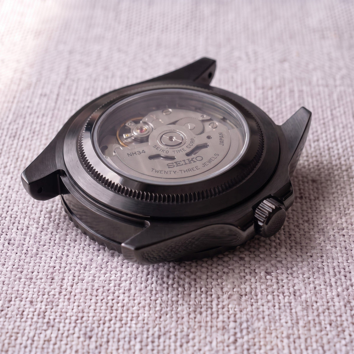 Open caseback showing the Seiko NH34 GMT automatic movement | caseback=Open